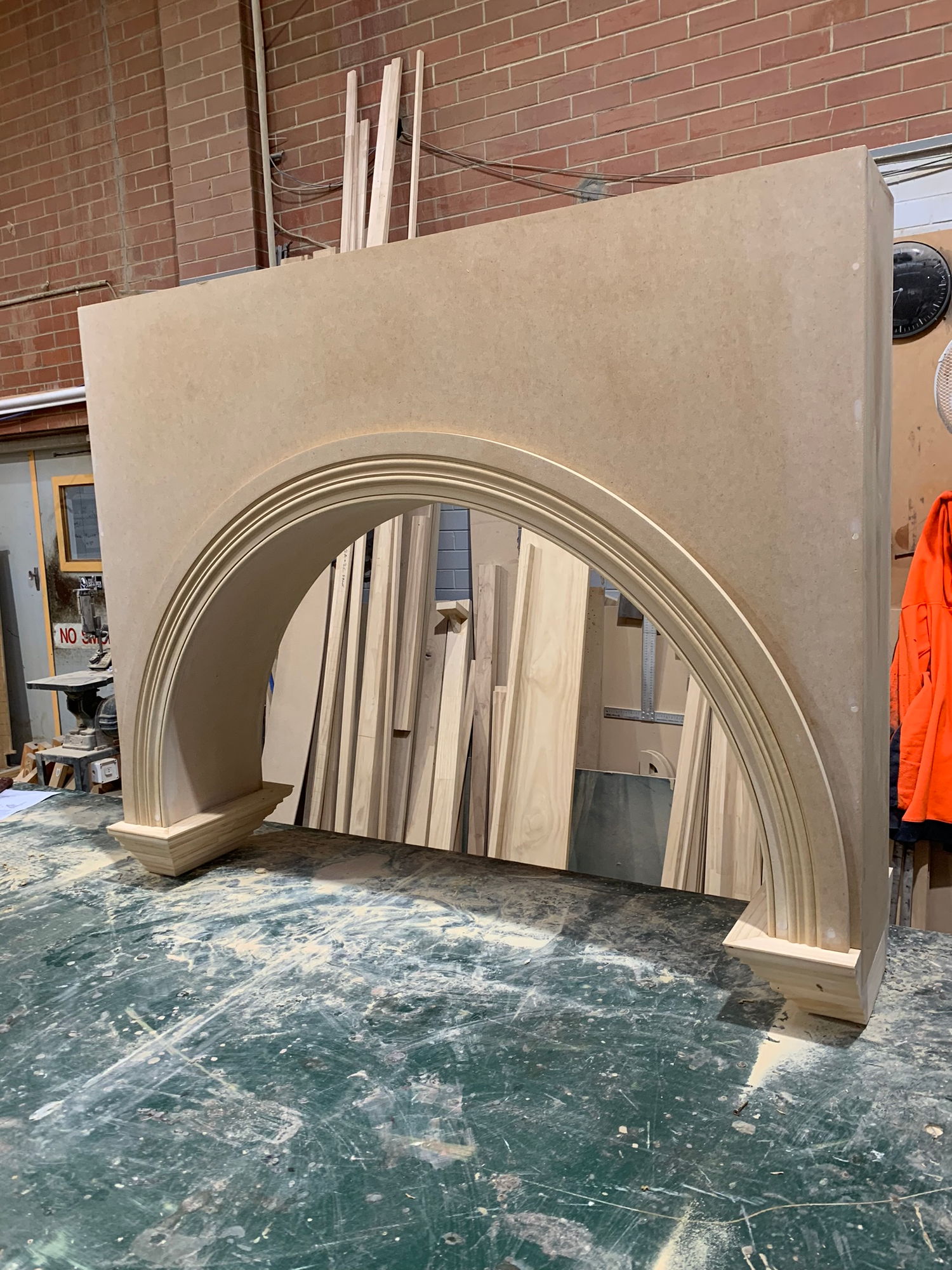 Timber arch head - a wide semicircular arch built up on the workshop bench