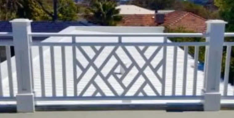 White lattice infill panel between capped balustrade posts