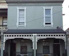 After restoration: the same terraces repainted with new pierced fretwork friezes