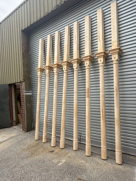 Turned timber verandah posts lined up outside the workshop