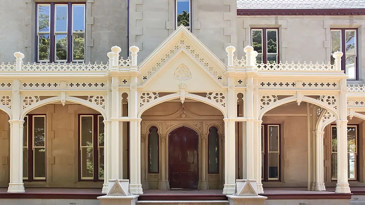 Heritage decorative timber - ornate cream verandah with arched brackets and lacework