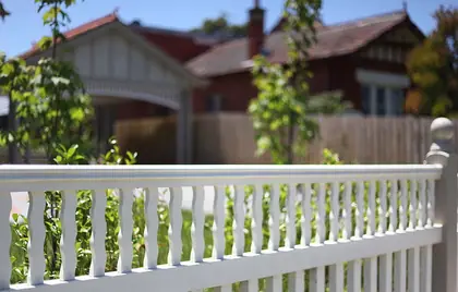White timber fence with shaped balusters above a picket base