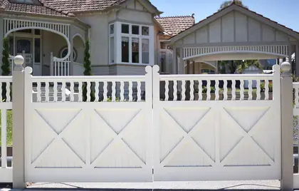 Pair of braced timber entry gates with a shaped baluster top rail