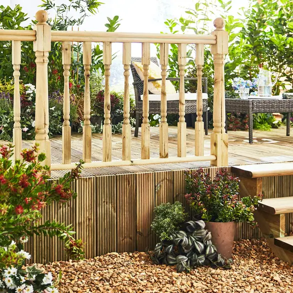 Timber balustrade with turned newels around a raised timber deck in a garden