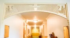 Fretwork archway spandrel fitted across an internal hallway