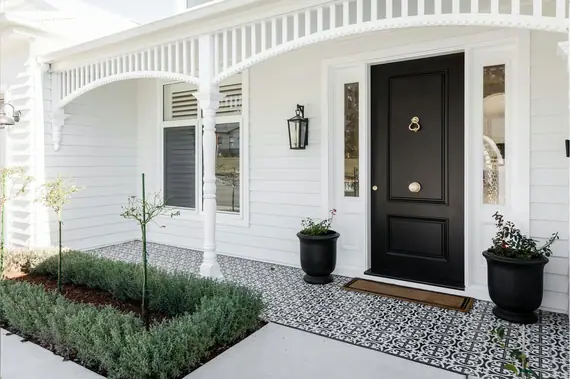 Arched timber frieze and a turned post over a weatherboard entry porch