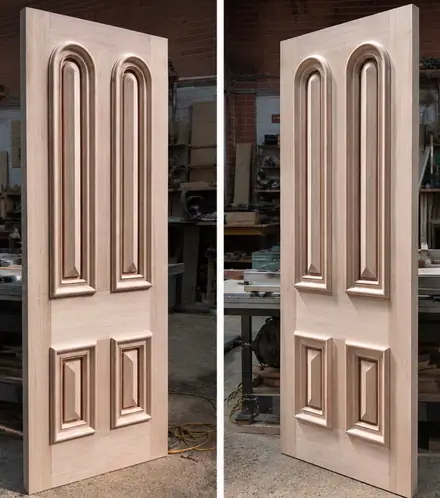 Two arched doors with raised and fielded panels on the workshop floor