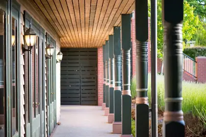 Turned timber verandah post - row of turned posts along a shaded verandah walkway