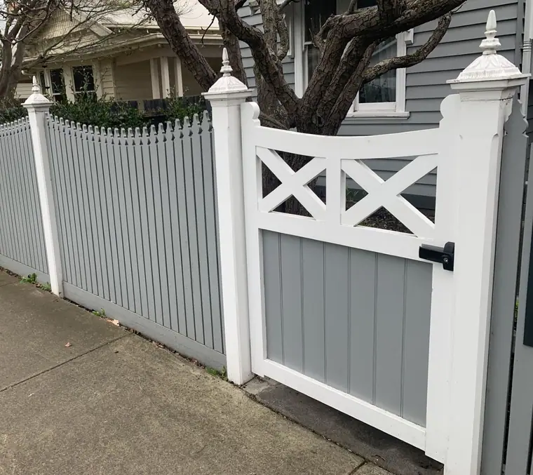 Timber gate - white picket gate with a cross-braced panel hung in a paling fence