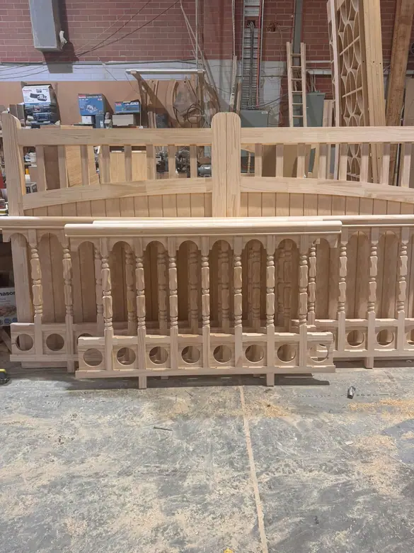 Assembled balustrade panels and an arched panel standing in the factory yard