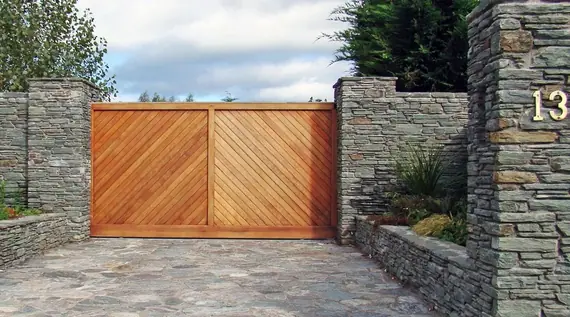Timber driveway gate - boards laid on the diagonal, hung between dry stone walls
