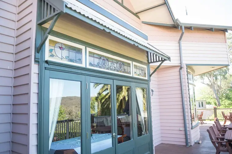 Timber window canopy - over glazed doors on a weatherboard wall
