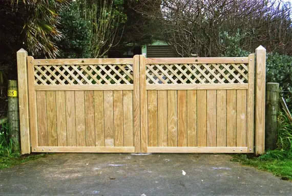 Timber driveway gates in a natural finish, with a lattice panel across the top