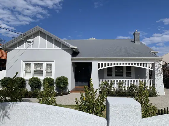 Heritage decorative timber - weatherboard bungalow with a fretwork frieze along the verandah