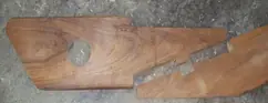 Machined hardwood component cut to a custom profile, on the workshop floor