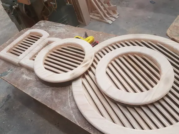 Timber gable vents - round and arched louvre vents on the workshop bench