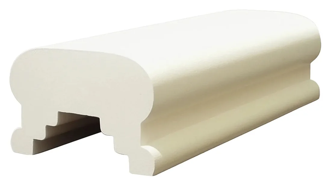 A timber handrail section shown whole, with the rebate along its underside that receives the balusters
