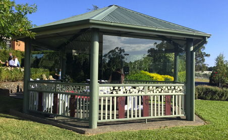 Assembled timber balustrade installed around a garden rotunda with a green roof