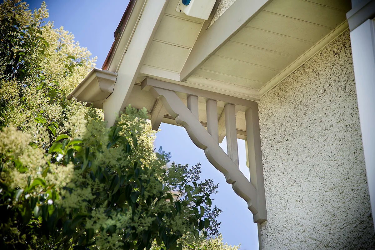 Timber corner bracket - eaves bracket under a verandah roof against the sky