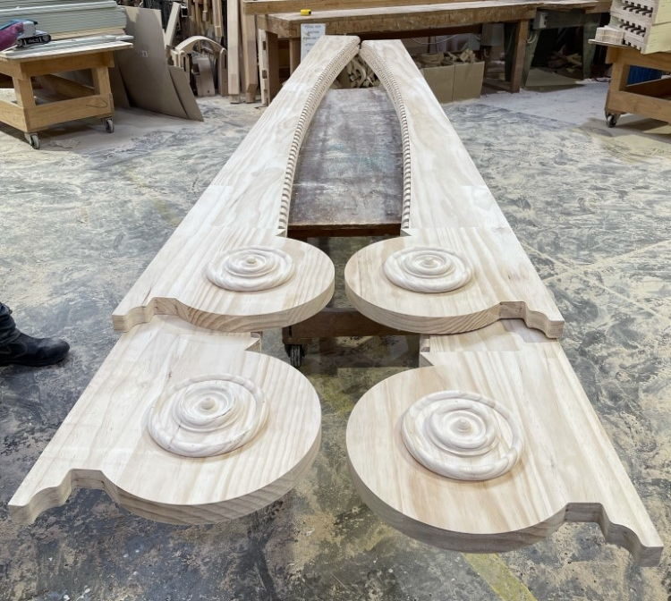 Decorative relief barge board - barge boards and turned rosettes being machined in the workshop