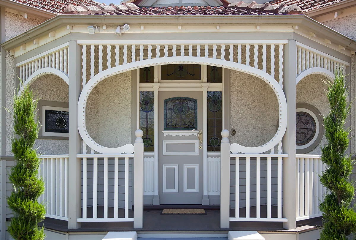 Heritage decorative timber - arched verandah brackets and balustrade on a rendered facade