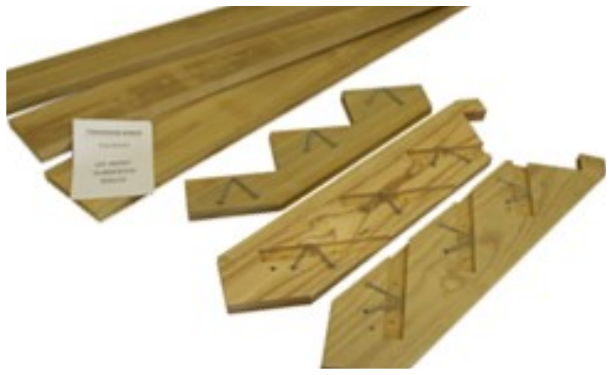 Flat-packed stair kit parts - sawtooth-cut stringers and treads - with its label