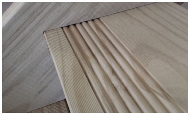 Close-up of a reeded timber stair tread, showing the grooved tread surface