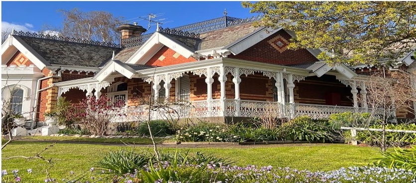 A period brick verandah with fretwork spandrels and brackets in every bay