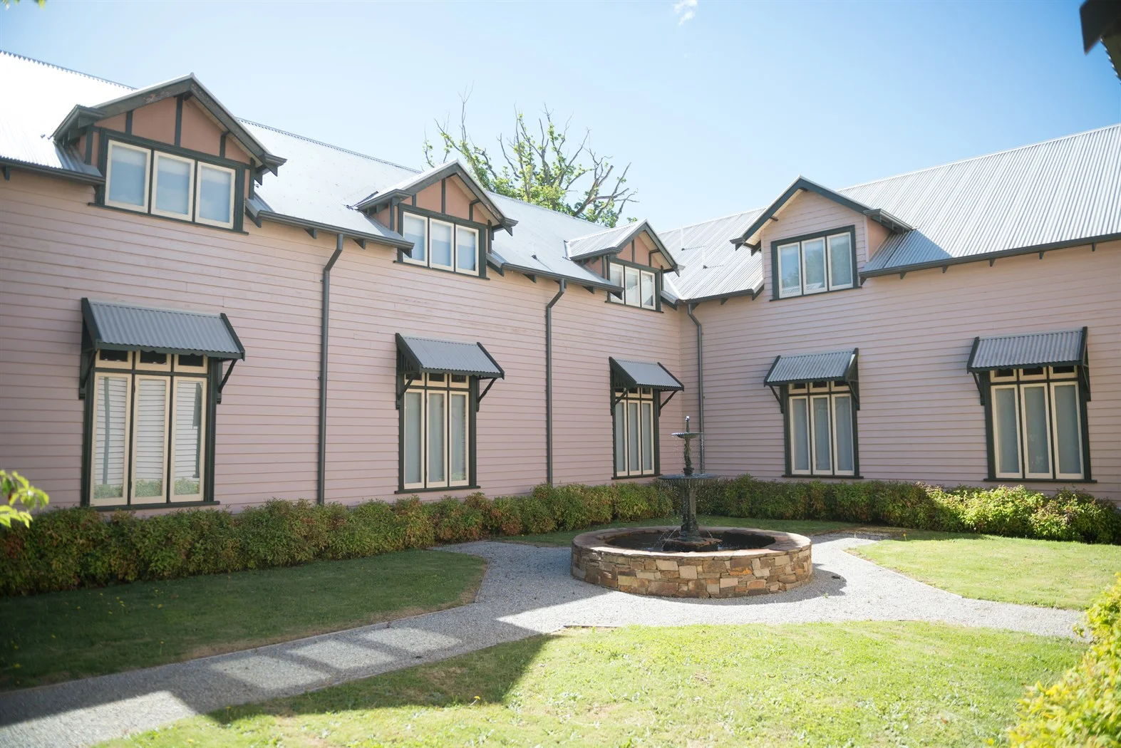 Decorative timber - row of timber window canopies across a weatherboard elevation